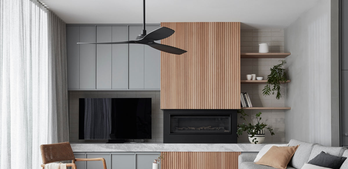 Black ceiling fan in a living room with grey cabinetry, a timber slat fireplace surround and open shelves