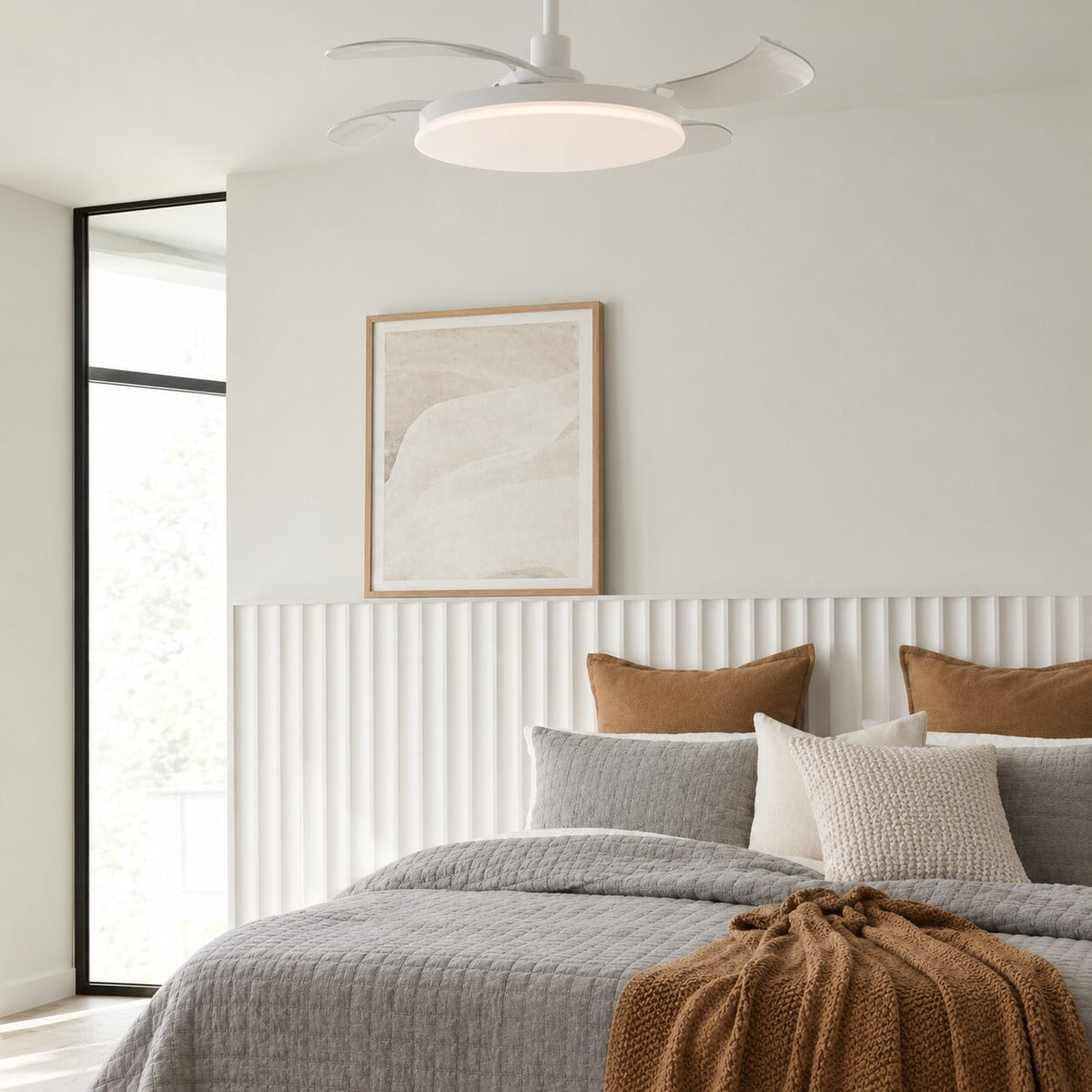 White Fanaway ceiling fan with a flat light above a bed with tan and grey cushions