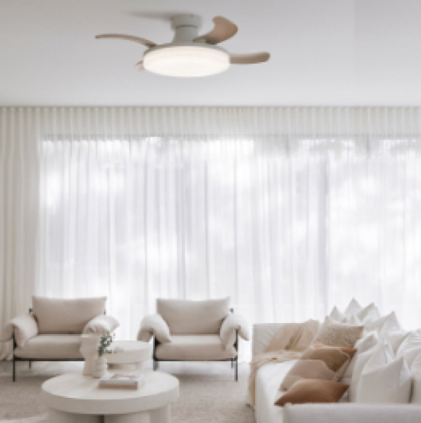 Compact white Fanaway ceiling fan with a light above a living room with cream armchairs and a sofa