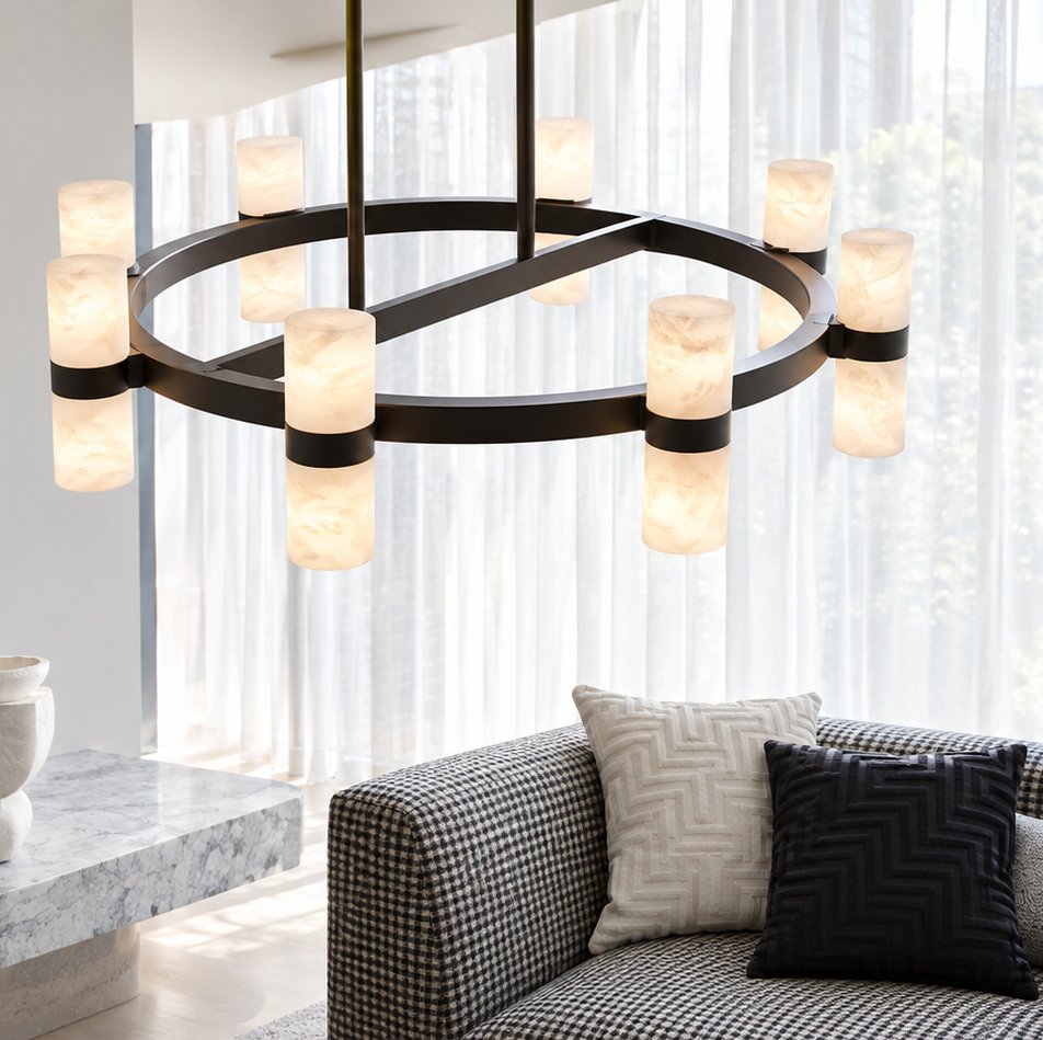 Black ring chandelier with alabaster cylinder lights above a houndstooth sofa and marble side table